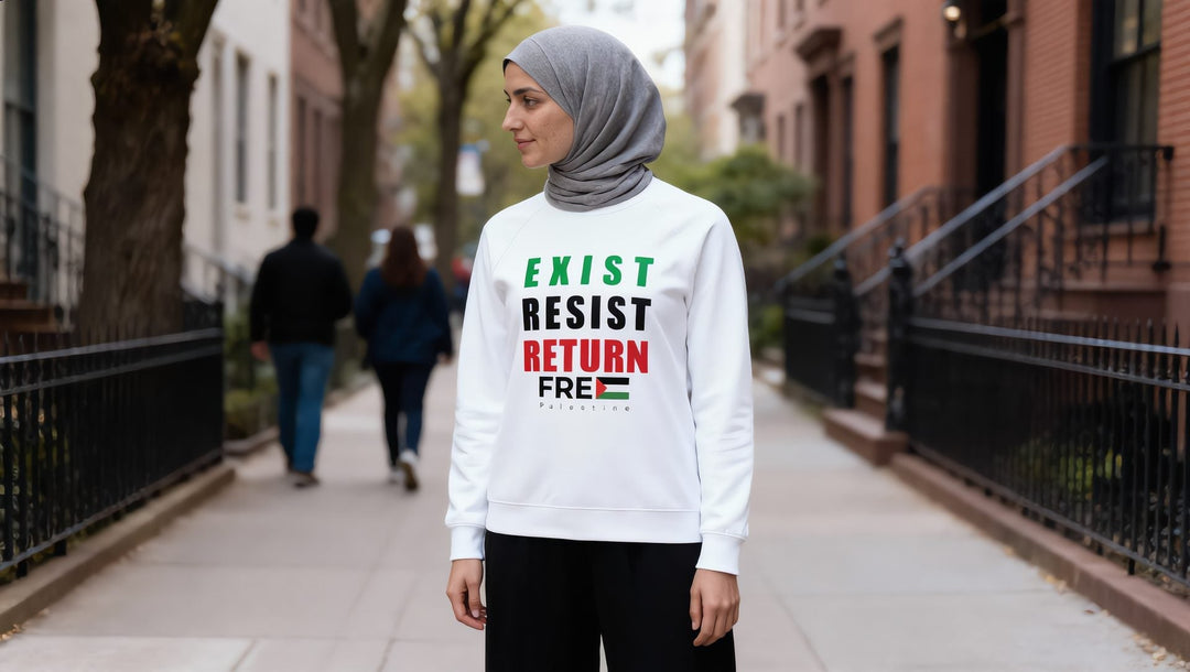 Woman in a white Exist Resist Return sweatshirt on a tree-lined street in Brooklyn Heights, New York