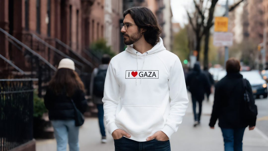 Man in a white I Love Gaza hoodie on a brownstone street in Brooklyn, New York