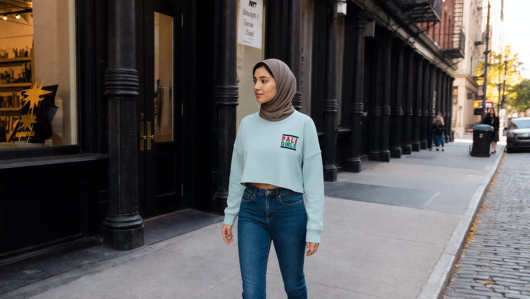 Woman in an embroidered Pali Girls crop sweatshirt on a SoHo street