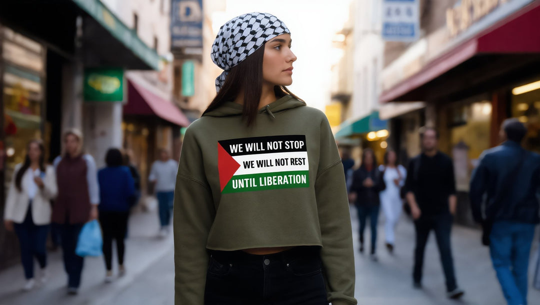 Woman in a We Will Not Stop crop hoodie on Steinway Street, Astoria