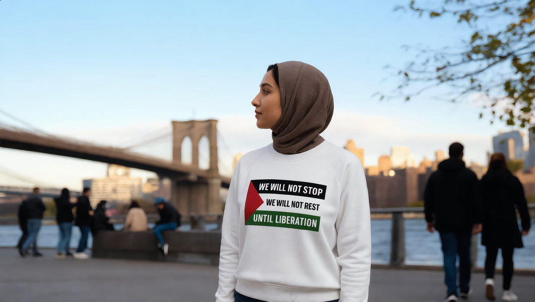 Woman in a We Will Not Stop sweatshirt near the Brooklyn Bridge walkway, New York