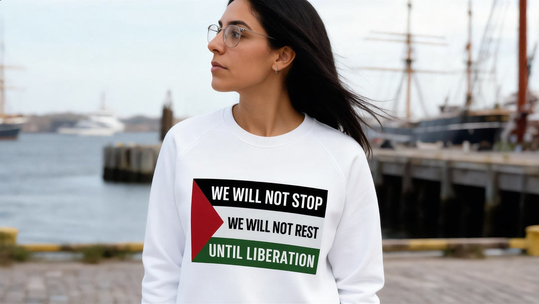 Woman in a We Will Not Stop sweatshirt at South Street Seaport looking at the East River, New York
