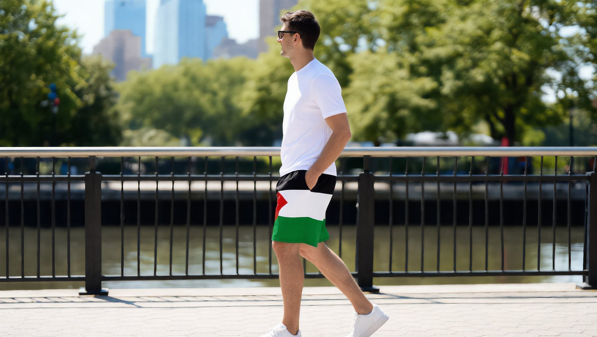 Man wearing Palestine flag mesh shorts on the Hudson River Park promenade, New York
