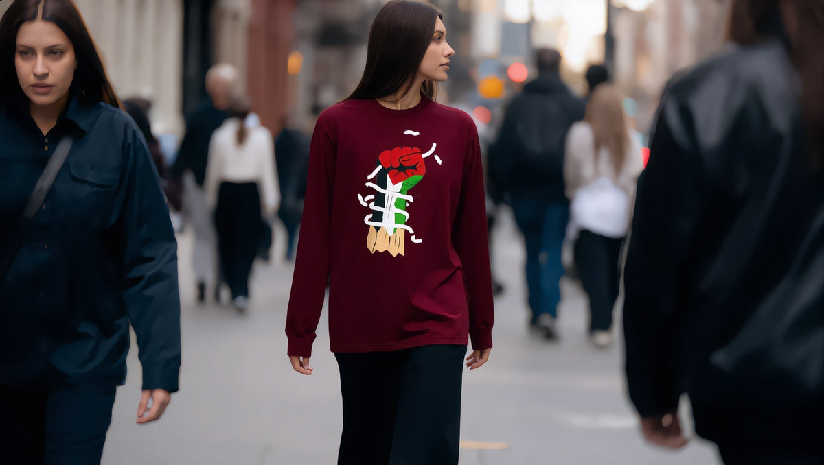 Woman wearing a Palestine Hand long sleeve tee on Court Street, Cobble Hill, Brooklyn