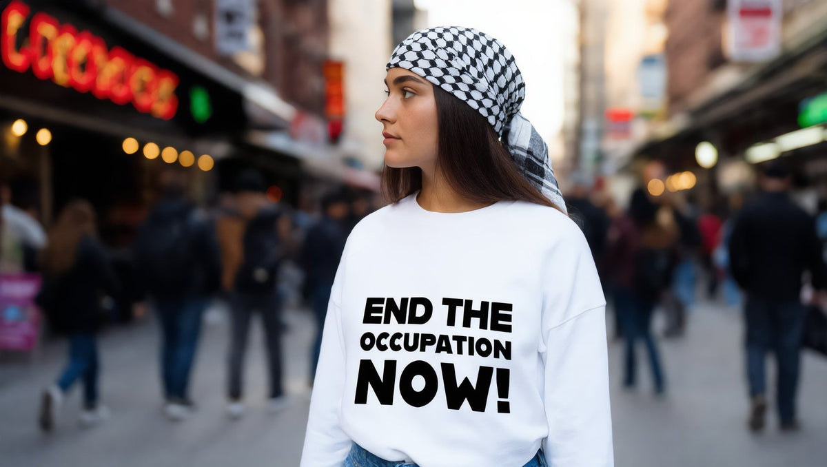 Woman wearing a white End the Occupation Now sweatshirt on Atlantic Avenue, Brooklyn