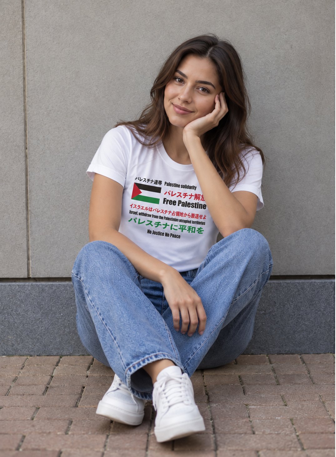 Woman in a Japanese Exclusive Free Palestine t-shirt sitting on a city step